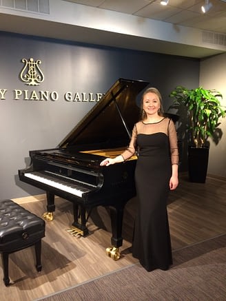 Elena Goptseva by the piano at Syeinway Piano Gallery.